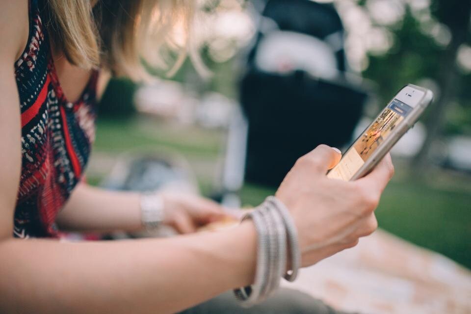 A woman holding a phone